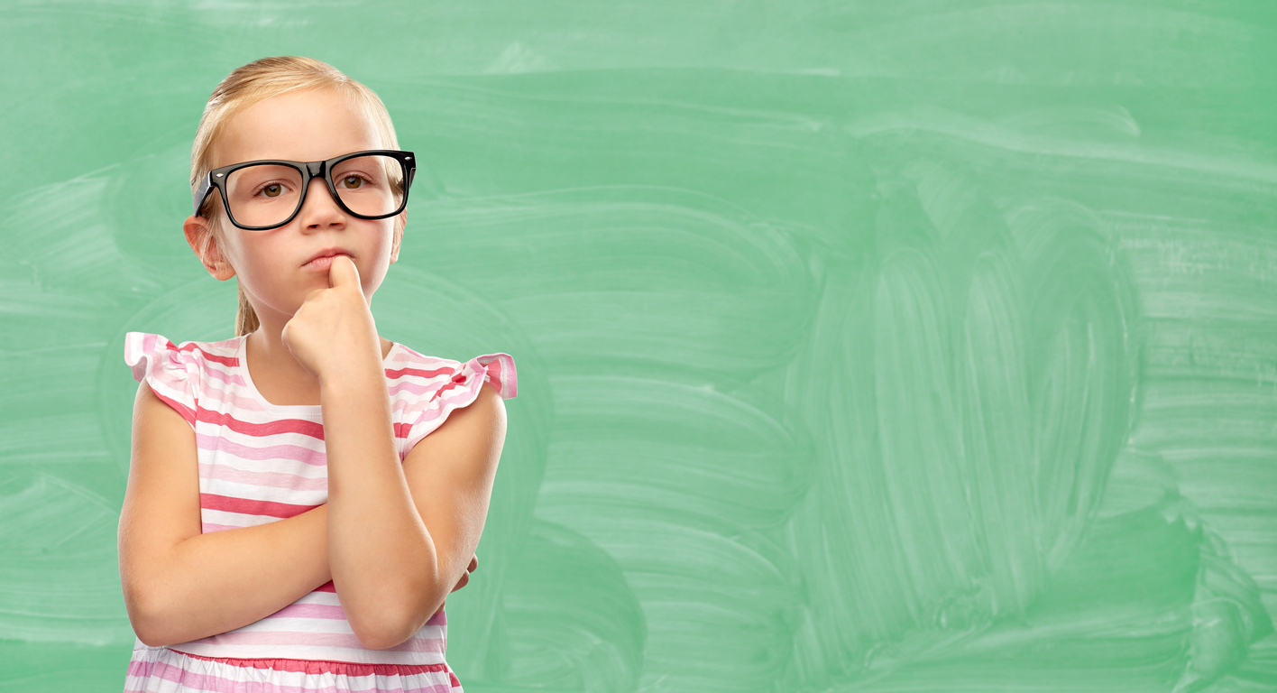 Little Girl in Glasses Thinking at School