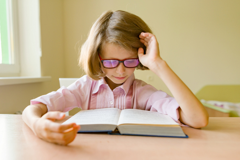 Little Girl with Glasses Reading